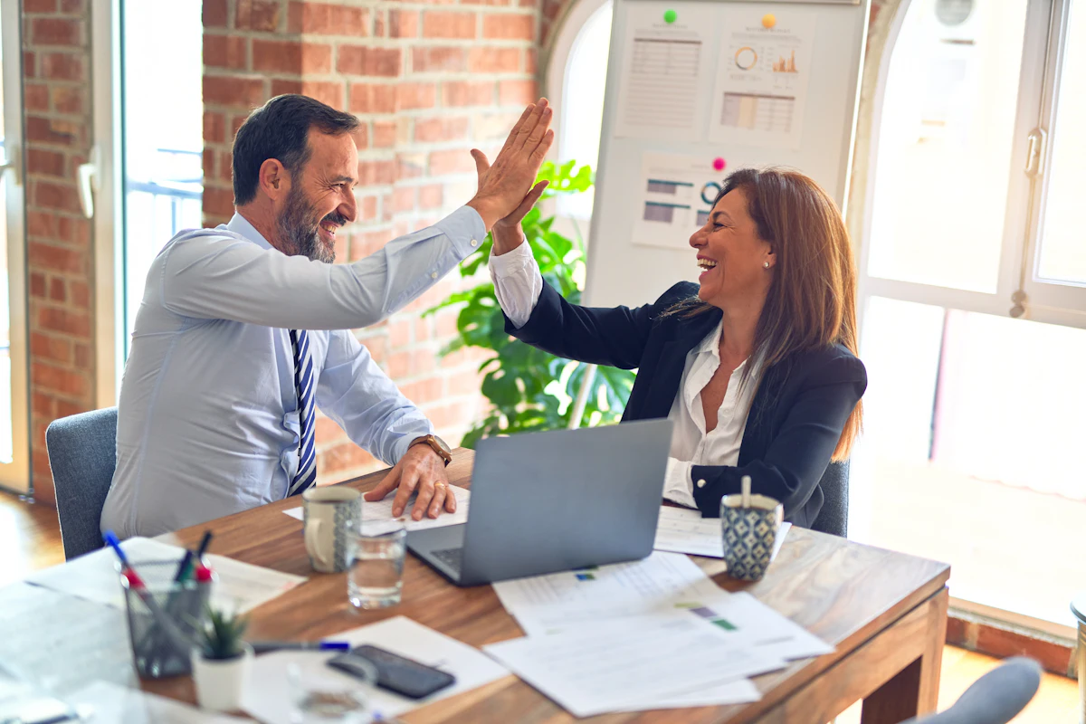 Two professionals celebrating a closed deal
