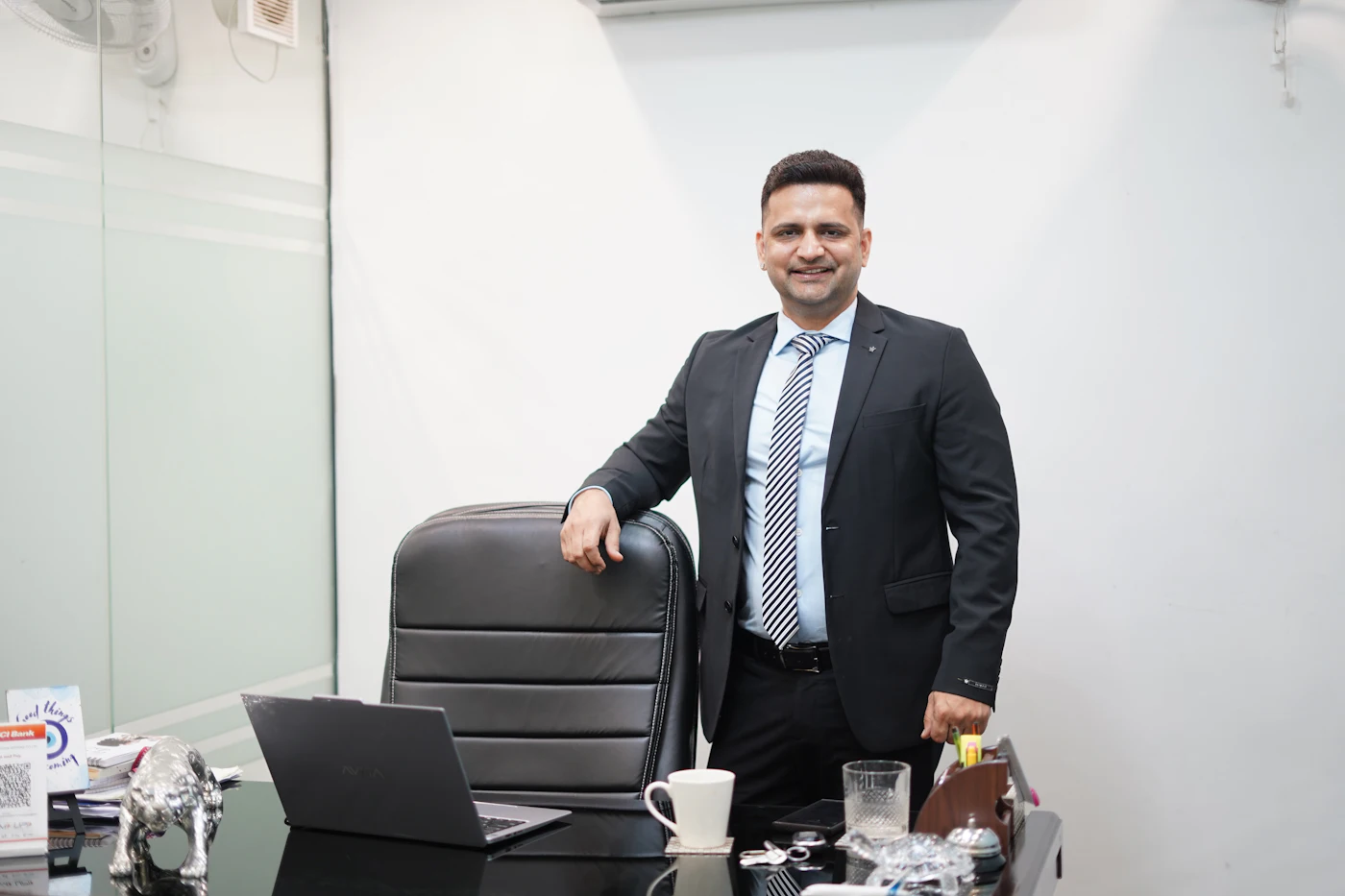 A smiling, successful real estate professional in his office