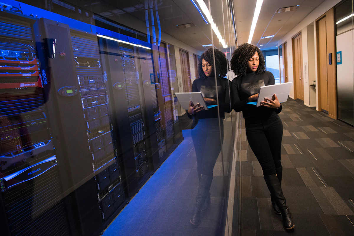 Professionals with laptops in a data centre